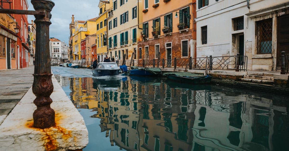 Charming view of a Venetian canal lined with colorful historic buildings and boats.